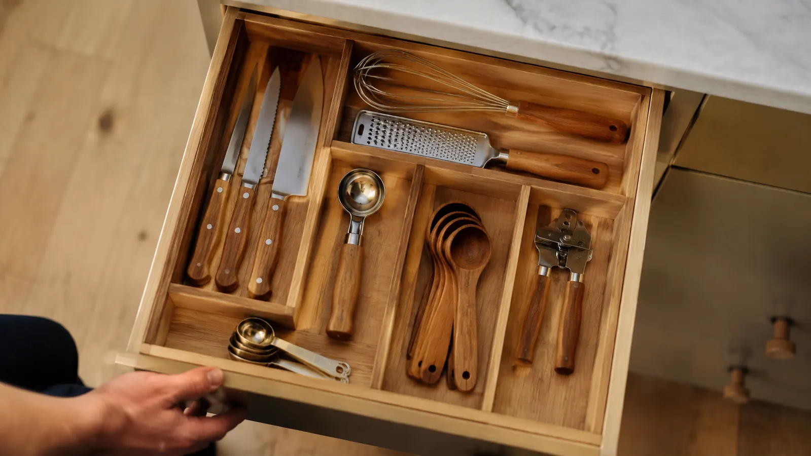 A tidy kitchen drawer with only a few well-chosen tools, representing a clutter-free cooking philosophy