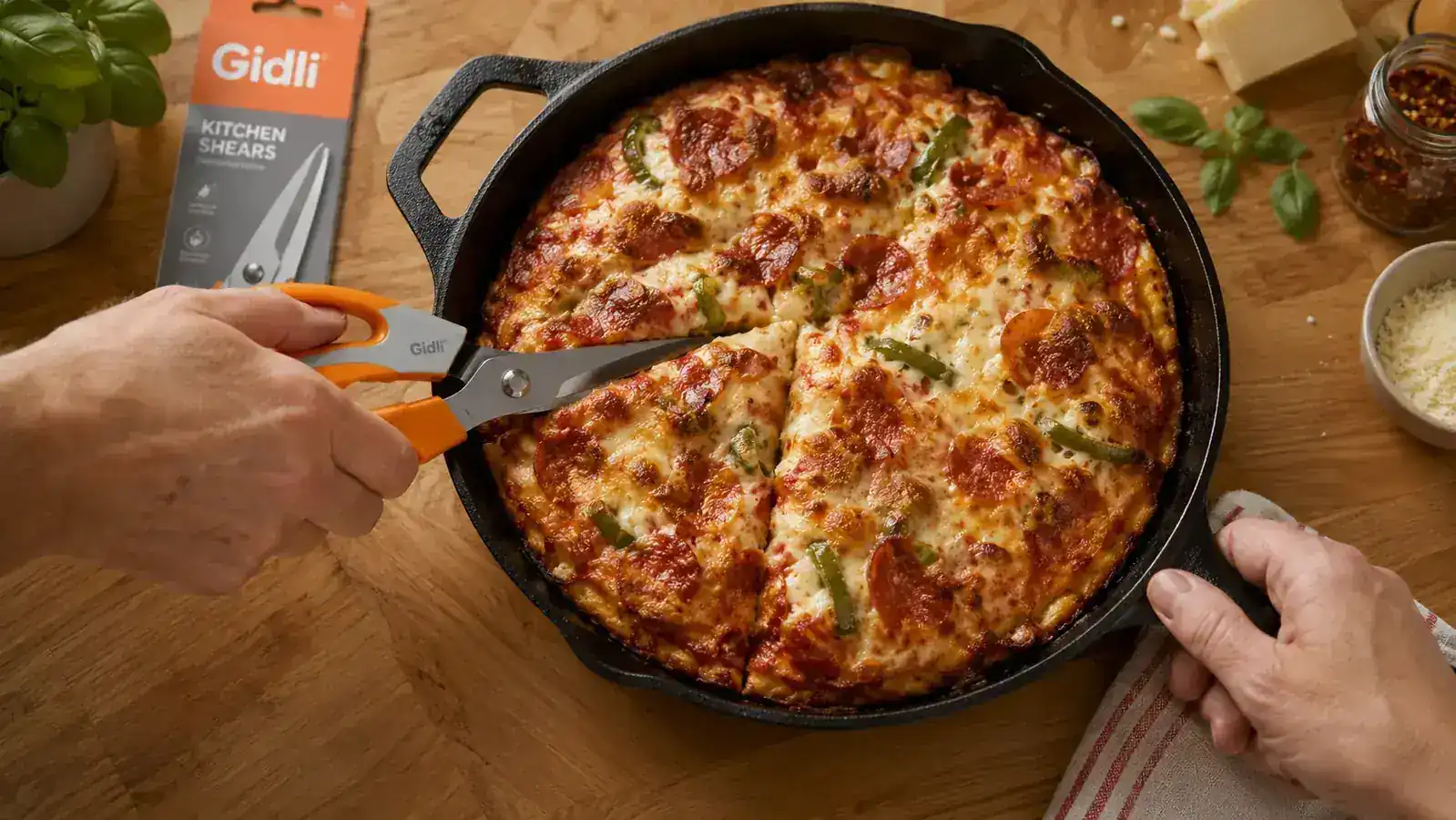 Kitchen shears cutting a homemade pizza directly in the pan into triangular slices